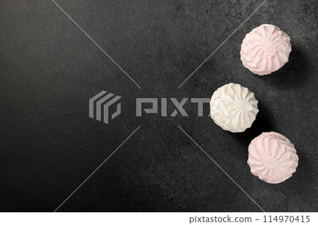 white and pink marshmallows on a black background 114970415