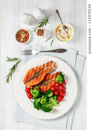 grilled salmon steaks with broccoli and tomatoes grilled salmon steaks with broccoli and tomatoes 114970549