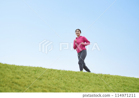 Middle-aged woman running in sportswear Middle-aged woman running in sportswear 114971211