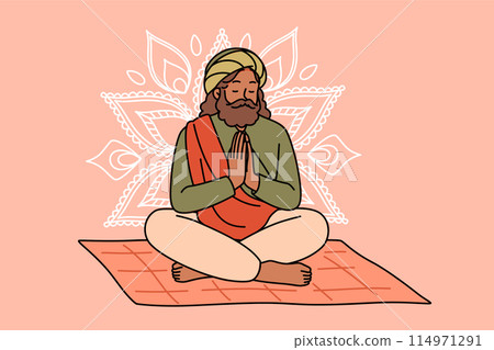Meditating Indian man fakir prays sitting cross-legged on mat with mandala sign behind back. Meditating Indian man fakir prays sitting cross-legged on mat with mandala sign behind back. 114971291