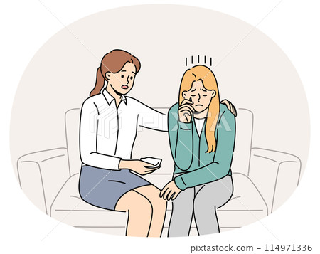 Crying woman at reception of psychologist consoling patient sitting on couch and experiencing stress Crying woman at reception of psychologist consoling patient sitting on couch and experiencing stress 114971336