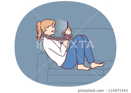 Young positive woman addicted to mobile phone sitting on sofa with chain around neck 114971443