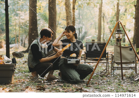 Asian couple sweet in tent inside on they camping trip, traveller relax and sleep togather in out door and camping trip 114971614