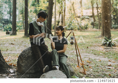 Asian couple sweet in tent inside on they camping trip, traveller relax and sleep togather in out door and camping trip Asian couple sweet in tent inside on they camping trip, traveller relax and sleep togather in out door and camping trip 114971615