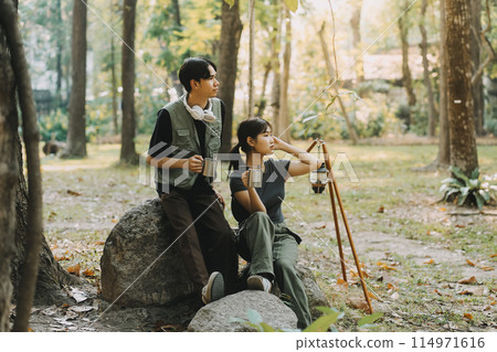 Asian couple sweet in tent inside on they camping trip, traveller relax and sleep togather in out door and camping trip Asian couple sweet in tent inside on they camping trip, traveller relax and sleep togather in out door and camping trip 114971616