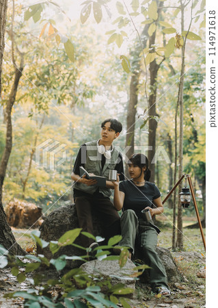 Asian couple sweet in tent inside on they camping trip, traveller relax and sleep togather in out door and camping trip 114971618