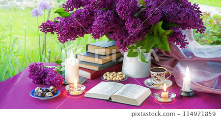 Antique still life with a bouquet of lilacs, coffee, books and candles 114971859
