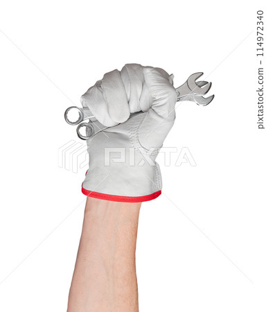 Hand with spanner in fist. White glove symbolizing work and protection. Isolated arm of man in 114972340