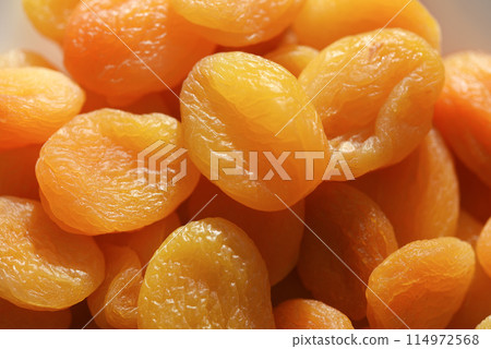 Dried fruits. Dried apricots. Dried apricots in close-up on a white plate. Dried fruits. Dried apricots. Dried apricots in close-up on a white plate. 114972568