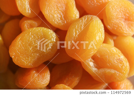 Dried fruits. Dried apricots. Dried apricots in close-up on a white plate. Dried fruits. Dried apricots. Dried apricots in close-up on a white plate. 114972569