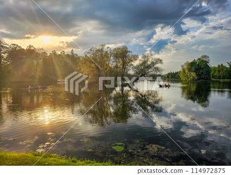 Beautiful spring view with sun over the lake and reflections in the water. 114972875