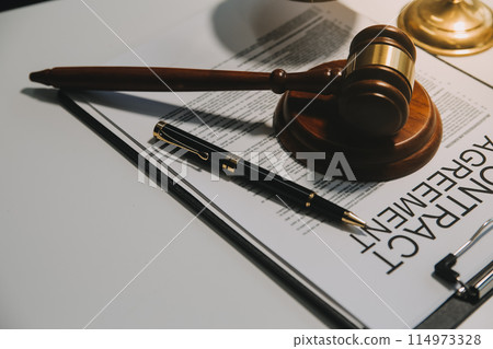 Lawyer, legal advisor, businessman brainstorming information on agreement details Business contracts in legal processing books for accuracy in contract documents. joint financial investment. 114973328