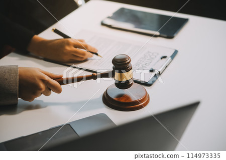 Lawyer, legal advisor, businessman brainstorming information on agreement details Business contracts in legal processing books for accuracy in contract documents. joint financial investment. 114973335
