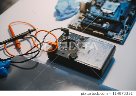 Close up of Technician measuring voltage electronic circuit board television, Service after sale fix electric equipment within insurance. 114973351
