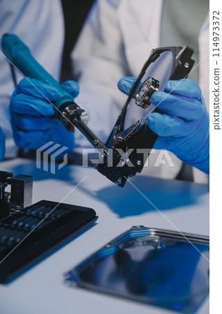 Close up of Technician measuring voltage electronic circuit board television, Service after sale fix electric equipment within insurance. Close up of Technician measuring voltage electronic circuit board television, Service after sale fix electric equipment within insurance. 114973372