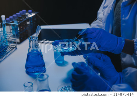 chemist,scientist hand dropping chemical liquid into test tube, science research and development concept chemist,scientist hand dropping chemical liquid into test tube, science research and development concept 114973414