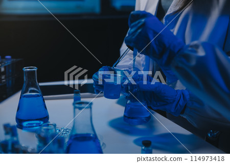 chemist,scientist hand dropping chemical liquid into test tube, science research and development concept 114973418