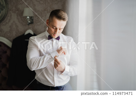 Beautiful man, groom posing and preparing for wedding 114973471