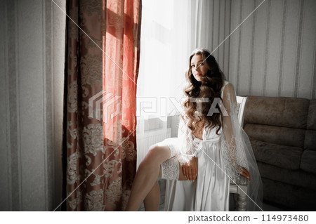 Portrait of beautiful bride with fashion veil at wedding morning 114973480