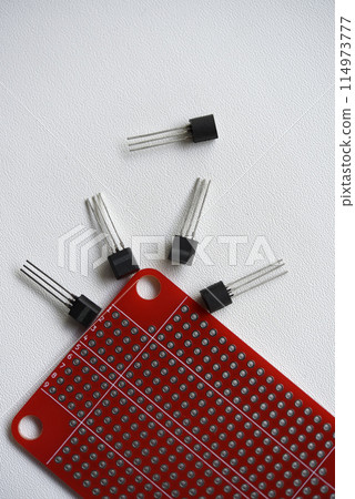 Red printed circuit board and chips and radio components. Capacitors and transistors. 114973777