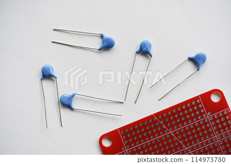Red printed circuit board and chips and radio components. Capacitors and transistors. Red printed circuit board and chips and radio components. Capacitors and transistors. 114973780