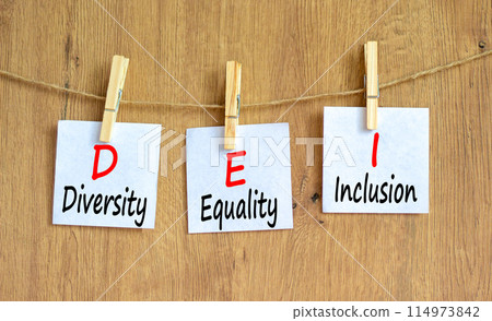 DEI diversity equality inclusion symbol. Concept words DEI diversity equality inclusion on beautiful paper. Beautiful wooden background. Business DEI diversity equality inclusion concept. Copy space. 114973842