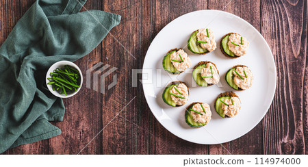 Appetizing sandwiches with pollock caviar, cucumber and herbs on a plate top view web banner Appetizing sandwiches with pollock caviar, cucumber and herbs on a plate top view web banner 114974000