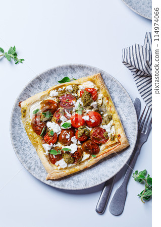 Pesto, tomato and feta tart. Pesto, tomato and feta tart. 114974066