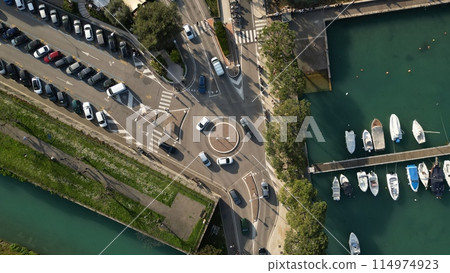 Top down view of traffic circle on Lake Garda. Aerial view of yachts on the pier. Peschiera del Garda, Italy Top down view of traffic circle on Lake Garda. Aerial view of yachts on the pier. Peschiera del Garda, Italy 114974923