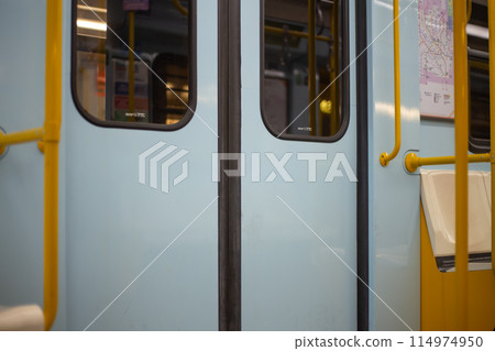 Closed doors in a subway car. An empty train waits at the San Donato metro station in Milan. Public transport concept 114974950