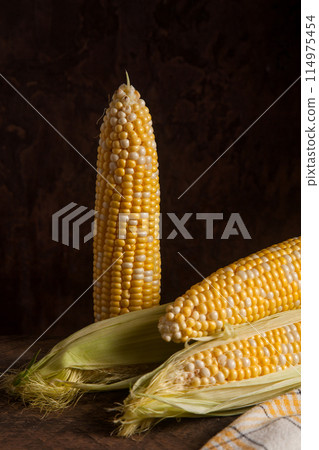 Several cobs sweet corn on wooden background.. Several cobs sweet corn on wooden background.. 114975454