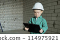 boy holds a black folder with documents in his hands and studies the room plans 114975921