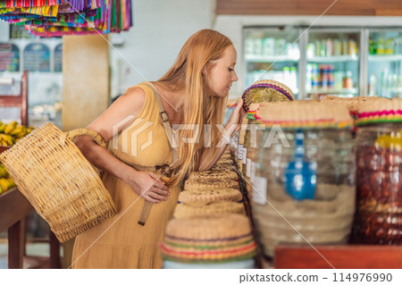 A pregnant woman is at a fruit stand in a grocery store Pregnant woman buying organic vegetables and fruits at Mexican style farmers market 114976990