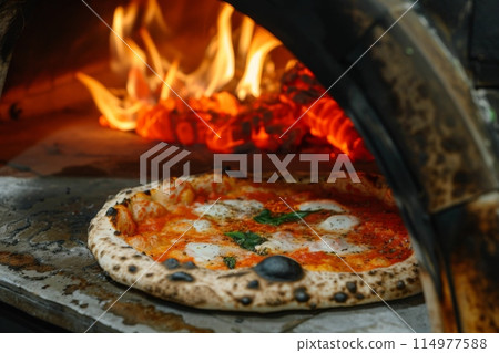 Pizza displayed on table near pizza oven, ready to eat 114977588