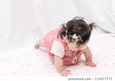[Baby with twin tails starting to crawl] 114977771
