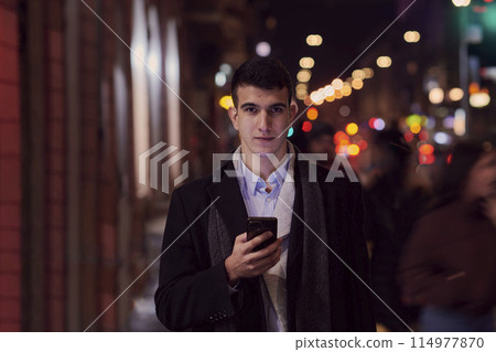 Smiling Meedle Eastern man walking down street near modern office building, Smiling Meedle Eastern man walking down street near modern office building, 114977870