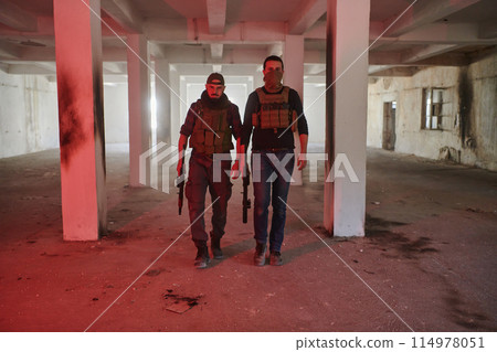 An abandoned building serves as the stronghold for a team of terrorists, fiercely guarding their occupied territory with guns and military equipment 114978051