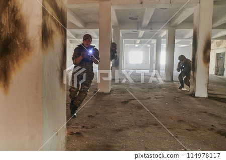 A group of professional soldiers bravely executes a dangerous rescue mission, surrounded by fire in a perilous building. A group of professional soldiers bravely executes a dangerous rescue mission, surrounded by fire in a perilous building. 114978117