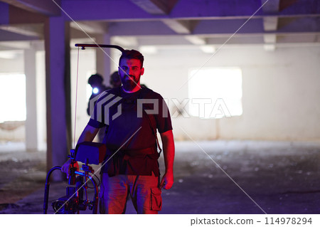 A professional cameraman captures the intense moments as a group of skilled soldiers embarks on a dangerous mission inside an abandoned building, their actions filled with suspense and bravery 114978294