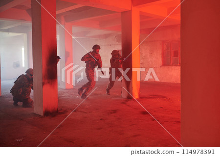 A group of professional soldiers bravely executes a dangerous rescue mission, surrounded by fire in a perilous building. A group of professional soldiers bravely executes a dangerous rescue mission, surrounded by fire in a perilous building. 114978391