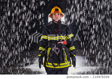 A determined female firefighter in a professional uniform striding through the dangerous, rainy night on a daring rescue mission, showcasing her unwavering bravery and commitment to saving lives. A determined female firefighter in a professional uniform striding through the dangerous, rainy night on a daring rescue mission, showcasing her unwavering bravery and commitment to saving lives. 114978509