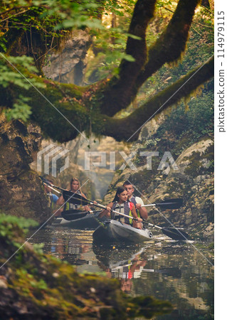 A group of friends enjoying having fun and kayaking while exploring the calm river, surrounding forest and large natural river canyons 114979115