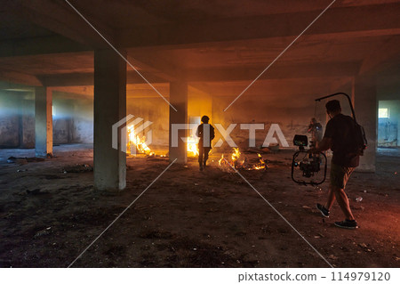 A professional cameraman captures the intense moments as a group of skilled soldiers embarks on a dangerous mission inside an abandoned building, their actions filled with suspense and bravery 114979120