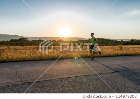 Triathlete in professional gear running early in the morning, preparing for a marathon, dedication to sport and readiness to take on the challenges of a marathon. Triathlete in professional gear running early in the morning, preparing for a marathon, dedication to sport and readiness to take on the challenges of a marathon. 114979208