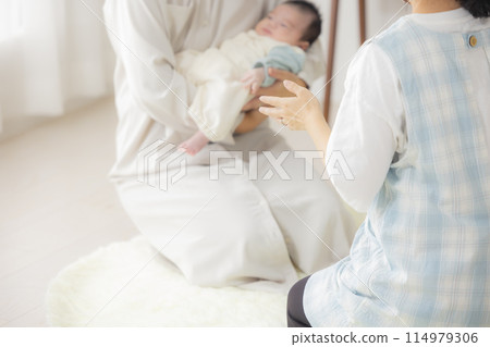 Baby and a home visit by a public health nurse Baby and a home visit by a public health nurse 114979306