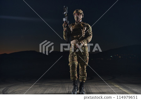 A professional soldier in full military gear striding through the dark night as he embarks on a perilous military mission A professional soldier in full military gear striding through the dark night as he embarks on a perilous military mission 114979651
