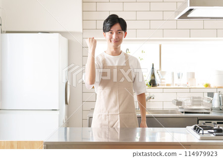 A man doing a fist pump in the kitchen A man doing a fist pump in the kitchen 114979923
