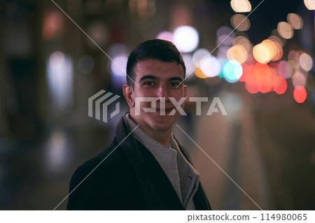 Smiling Meedle Eastern man walking down street near modern office building, Smiling Meedle Eastern man walking down street near modern office building, 114980065
