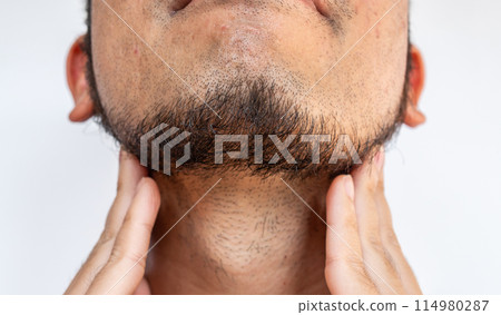 Cropped shot of Asian man touching his beard grows on a part of his lower face. Beard can make you feel more attractive. 114980287