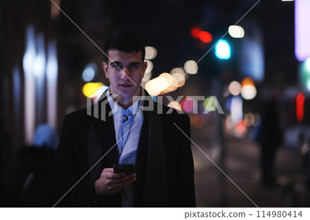 Smiling Meedle Eastern man walking down street near modern office building, Smiling Meedle Eastern man walking down street near modern office building, 114980414